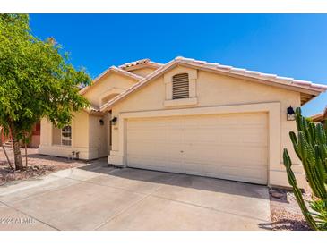 Tan two-car garage home with terracotta roof and landscaping at 745 E Megan St, Chandler, AZ 85225