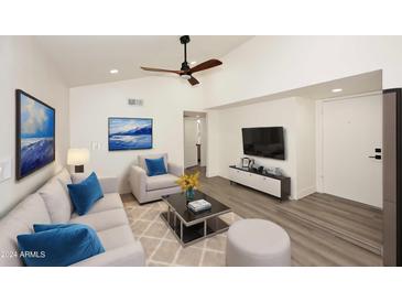 Bright living room with vaulted ceiling, comfy seating, and modern decor at 916 S Melody Ln, Tempe, AZ 85281