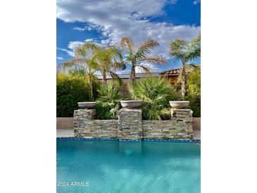 Relaxing pool area with a stone water feature at 18206 W Sells Dr, Goodyear, AZ 85395
