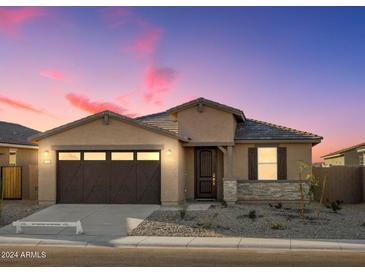 Tan house with brown garage door and stone accents at 37375 W Patterson St, Maricopa, AZ 85138