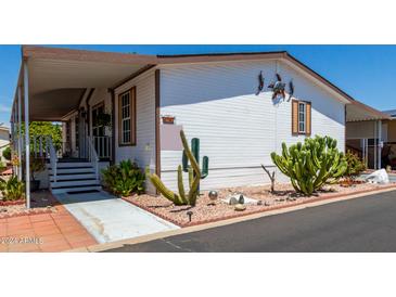 Nice single wide mobile home with covered porch and cacti at 11596 W Sierra Dawn Blvd # 196, Surprise, AZ 85378
