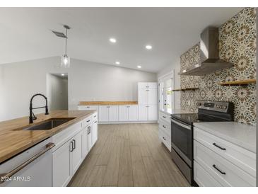 Modern kitchen with butcher block island and tile backsplash at 6802 E Beverly Ln, Scottsdale, AZ 85254