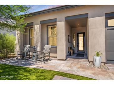 Inviting front porch with rocking chairs and a view of the front yard at 4226 E Coconino Pl, Chandler, AZ 85249