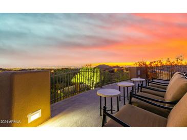 Peaceful patio with chairs and tables overlooking city lights at sunset at 8157 E Sierra Morena St, Mesa, AZ 85207