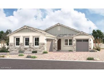 Two-story house with stone and wood accents, two-car garage at 12015 W Parkway Ln, Avondale, AZ 85323