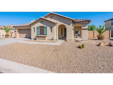 One-story home with green shutters and gravel landscaping at 40350 W Art Pl, Maricopa, AZ 85138