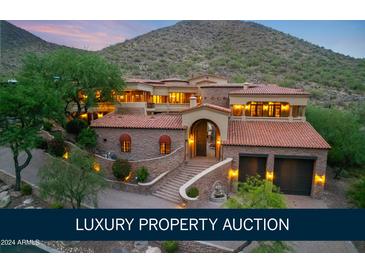 Luxury property auction: Stunning aerial view of a multi-level home nestled in the mountains at 12913 N 119Th St, Scottsdale, AZ 85259