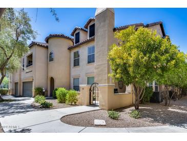 Two-story townhome with gated entry and mature landscaping at 14575 W Mountain View Blvd # 322, Surprise, AZ 85374