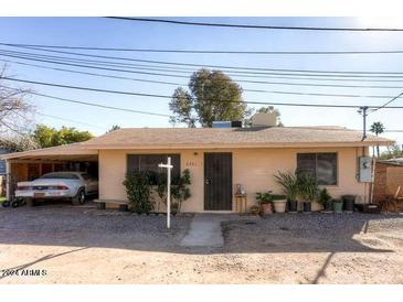 Ranch style home with carport and landscaping at 6321 N 65Th Dr, Glendale, AZ 85301
