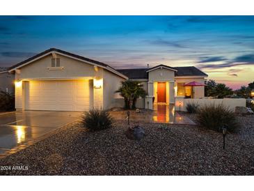 Attractive single-story home with a two-car garage and well-manicured landscaping at 42818 W Morning Dove Ln, Maricopa, AZ 85138