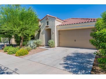 Single-story home with attached garage and nicely landscaped front yard at 10511 E Corbin Ave, Mesa, AZ 85212