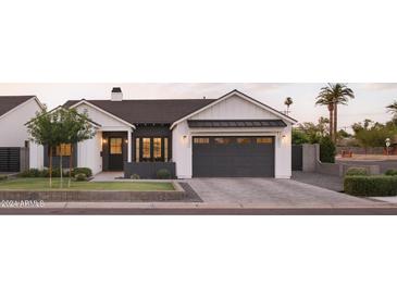 Stunning farmhouse style home with a dark gray garage door at 6836 N 13Th Pl # B, Phoenix, AZ 85014