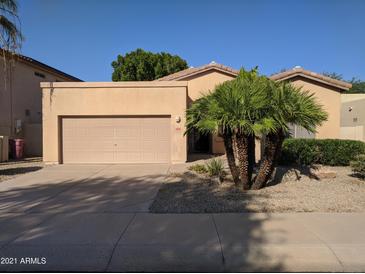 Single story home with a two car garage and desert landscaping at 15151 N 100Th Way, Scottsdale, AZ 85260