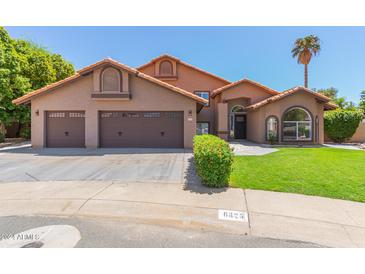 Two-story home with three-car garage and landscaping at 6325 E Monte Cristo Ave, Scottsdale, AZ 85254