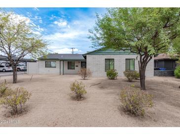 Brick house with green trim and desert landscaping at 1818 W Thomas Rd, Phoenix, AZ 85015