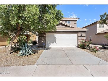 Two-story house with a two car garage and landscaped front yard at 31777 N Sundown Dr, San Tan Valley, AZ 85143
