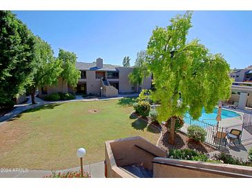 Community view with pool, grass, and trees at 5998 N 78Th St # 208, Scottsdale, AZ 85250