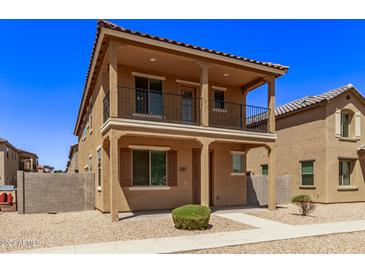Two story home with balcony and desert landscaping at 853 E Agua Fria Ln, Avondale, AZ 85323