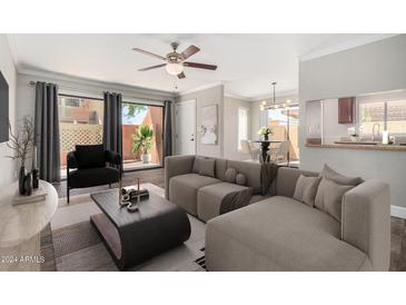 Spacious living room with comfortable seating and access to a patio at 3500 N Hayden Rd # 907, Scottsdale, AZ 85251