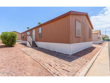 Single-wide manufactured home with brick pathway at 9431 E Coralbell Ave # 172, Mesa, AZ 85208