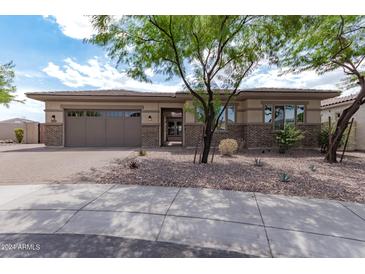 One-story home with a two-car garage and landscaped yard at 10005 W Spur Dr, Peoria, AZ 85383