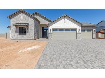 Two-story home with a three-car garage and stone accents at 1606 E Minton St, Mesa, AZ 85203