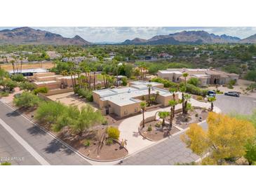 Aerial view of a house with a large yard and mountain views at 6023 E Turquoise Ave, Paradise Valley, AZ 85253