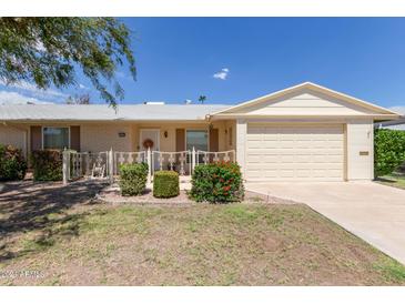 Ranch style home with a one car garage and small front yard at 10318 W Desert Forest Cir, Sun City, AZ 85351