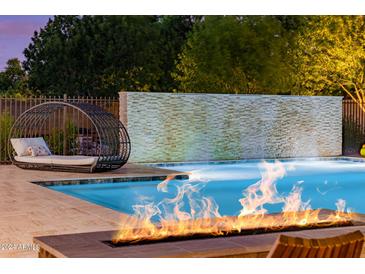 Luxury pool with fire pit, water feature, and comfortable seating at 12651 S 71St St, Tempe, AZ 85287