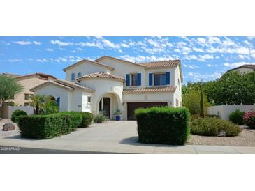 Two-story house with blue shutters, landscaping, and a driveway at 6251 S Moccasin Trl, Gilbert, AZ 85298