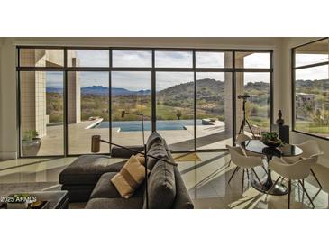 Spacious living room with stunning views and access to a pool at 15332 E Hidden Springs Trl, Fountain Hills, AZ 85268