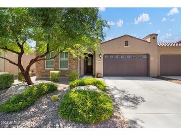 Beautiful home exterior with landscaping and two-car garage at 16881 W Merrell St, Goodyear, AZ 85395