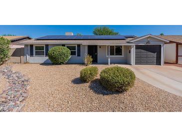 Ranch style home with solar panels and a two-car garage at 3708 E Joan De Arc Ave, Phoenix, AZ 85032