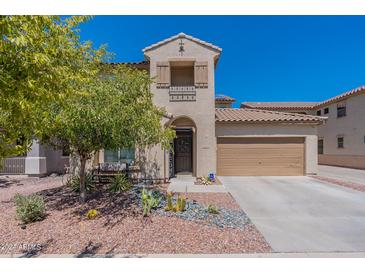 Two-story home with welcoming front porch and landscaping at 14760 W Riviera Dr, Surprise, AZ 85379