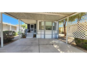 Mobile home exterior with carport and landscaping at 2233 E Behrend Dr # 41, Phoenix, AZ 85024