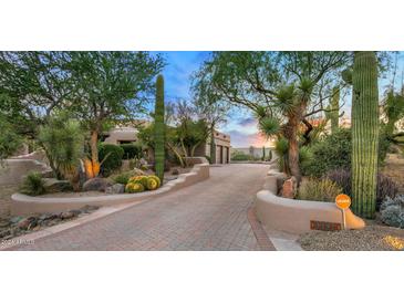 Landscaped front yard with a long driveway leading to a beautiful home at 9197 E Bajada Rd, Scottsdale, AZ 85262