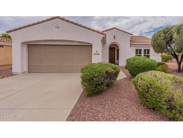 Beautiful stucco home with two-car garage and landscaping at 13441 W El Sueno Ct, Sun City West, AZ 85375