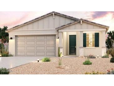 Modern home with a beige exterior and green front door at 24553 W Hopi St, Buckeye, AZ 85326