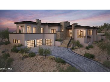 Modern home with stone accents and a three-car garage at 10039 N Mcdowell View Trl, Fountain Hills, AZ 85268