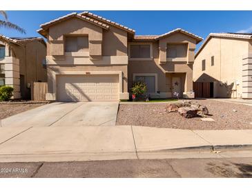 Two-story house with a two-car garage and desert landscaping at 2104 E 36Th Ave, Apache Junction, AZ 85119