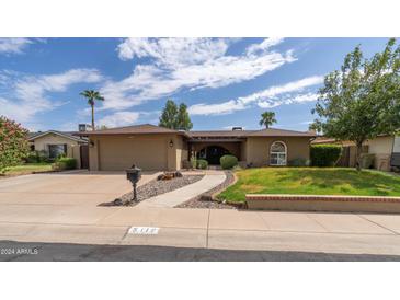 Ranch style home with two car garage and landscaped yard at 5119 W Onyx Ave, Glendale, AZ 85302
