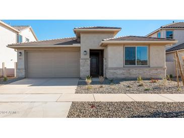 One-story home with stone accents and a two-car garage at 9935 S Centennial Rd, Apache Junction, AZ 85120