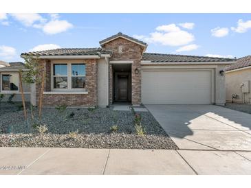 Single story home with brick facade and two car garage at 1521 W Saddle Run, Apache Junction, AZ 85120
