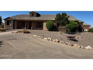 One-story home with stone accents and a landscaped yard at 376 N Iron Horse Dr, Coolidge, AZ 85128