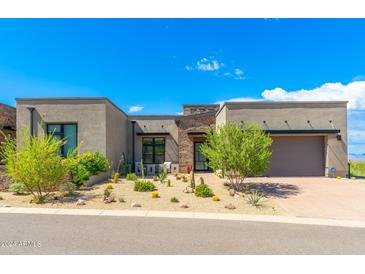 Modern home exterior with desert landscaping and two-car garage at 12498 E Troon Vista Dr, Scottsdale, AZ 85255