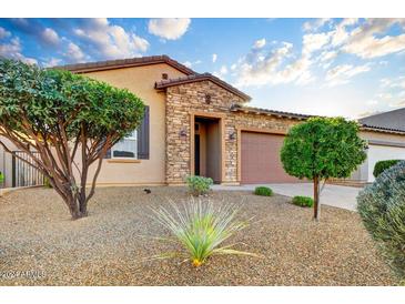 Single story home with stone accents and landscaping at 18789 E Blue Sky Dr, Rio Verde, AZ 85263