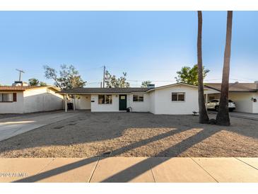 Updated single story home with a freshly painted exterior and landscaped front yard at 713 W 19Th St, Tempe, AZ 85281