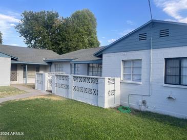 Front view of a light blue house with a well-maintained lawn at 2941 N 19Th Ave # 84, Phoenix, AZ 85015