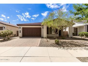 Single-story home with brown garage door and landscaping at 19314 S 208Th Pl, Queen Creek, AZ 85142