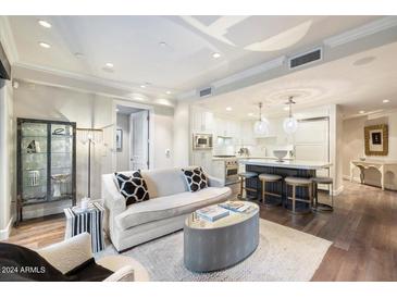 Open living room and kitchen with modern design and hardwood floors at 7175 E Camelback Rd # 107, Scottsdale, AZ 85251